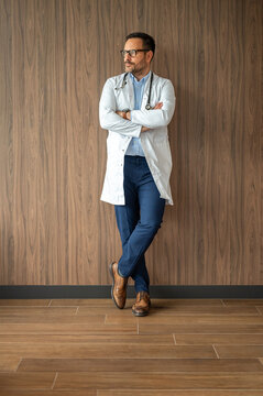 Dedicated health professional standing with crossed arms, portraying a thoughtful demeanor and embodying a trusted role in the healthcare industry, reflecting medical guidance