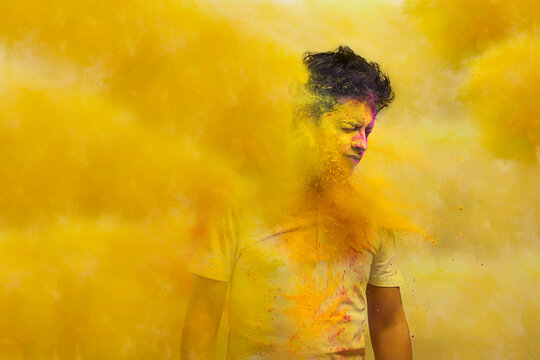 Young man with holi colors