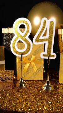 Gold Number 84 with Gold Glitter Confetti Sparkles with Gifts and Balloons for Party Eighty Four 4k Vertical