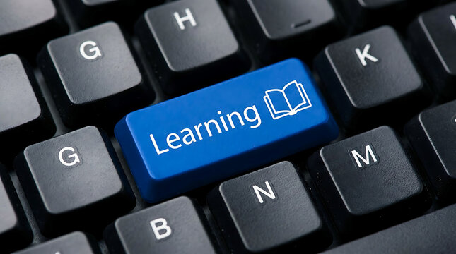 Blue learning key on modern computer keyboard for education concept