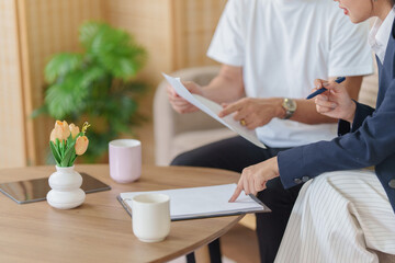Fototapeta premium Cropped view of advisor and client signing contract agreement during consultation