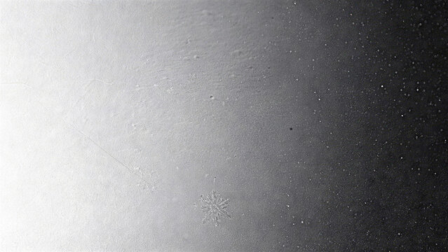 Monochrome silver gray film grain texture with soft dark gradient