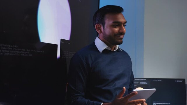Indian male Software Engineer, Developer working with Team, Looking at Monitoring, Presenting coding, data, AI Machine Learning Model to Colleague, Discussion, Reviewing and Brainstorming together.