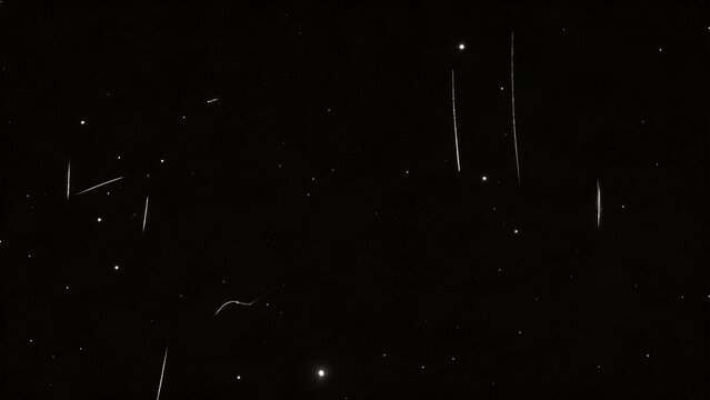 Sparse white dust and vertical scratches on pure black old film overlay