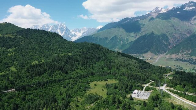 Ushba Massif aerial panorama, Hatsvali Svaneti mountain forest glacier landscape. Greater Caucasus summer scenery near Mestia, Georgia.