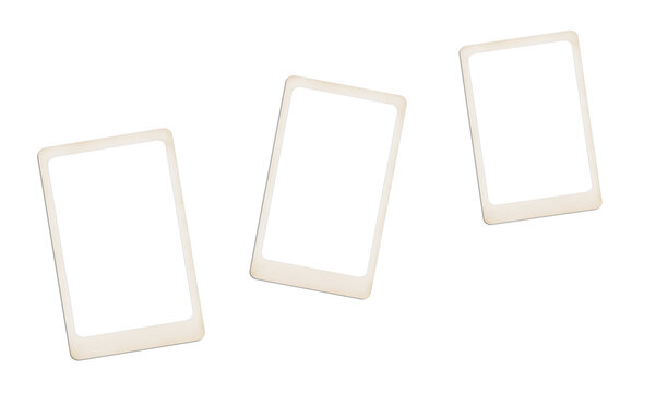 Three vintage polaroid photo frames with white borders scattered on a grey background.