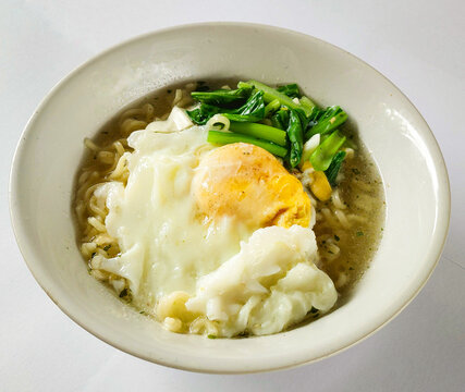 Hot Indonesian Mie Rebus Noodle Soup with Fried Egg and Vegetables
