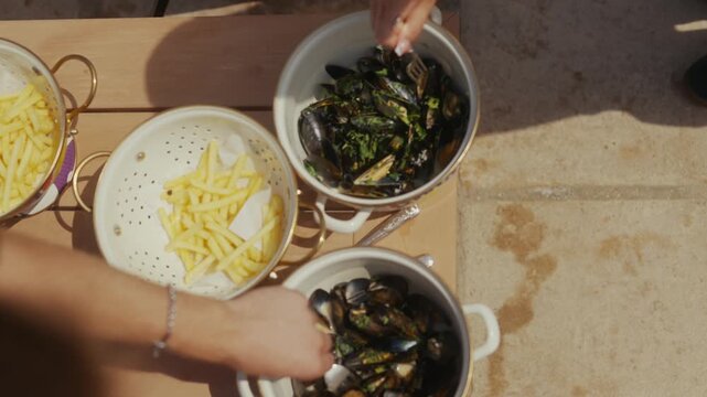 Close-up of mussels and fries on a table in a seaside restaurant