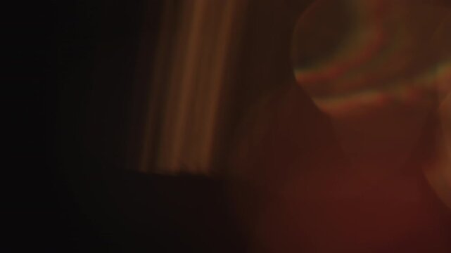 Slow motion real lens flare from back sunlight over dark background for overlay