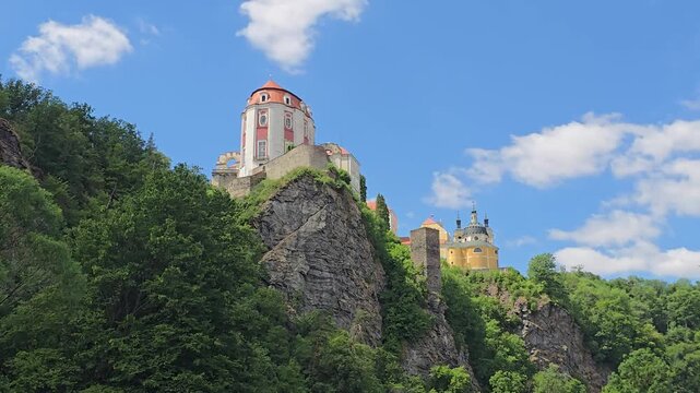 Beautiful timelapse of Vranov nad Dyj&iacute; Castle, a magnificent Baroque landmark in South Moravia, Czech Republic. Perched dramatically on a rocky cliff above lush forests under a blue summer sky with dr