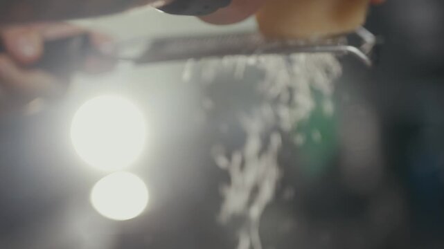 Knife slices through ice as it falls onto a glass surface.