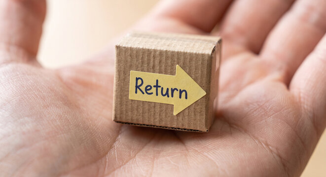 Person holding small cardboard box with return text on yellow arrow sticker, product return and refund concept.
