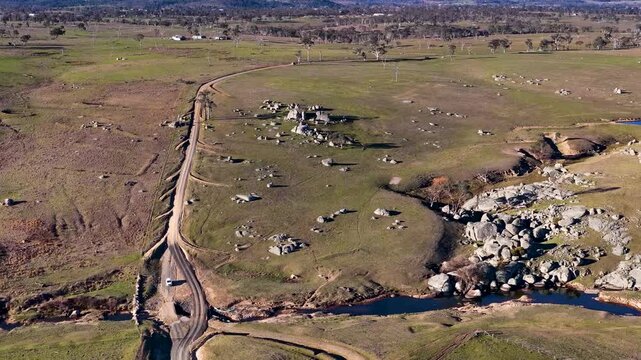 Aerial View of Dirt Road and Granite Boulders in Rural Australia