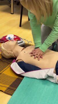 Riga,Latvia 06-jun-20Woman practicing CPR chest compressions on a training manikin during a first aid course, emergency response training, lifesaving skills, healthcare education, safety preparedness.