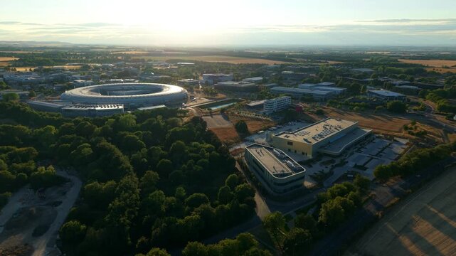Aerial view of modern circular synchrotron particle accelerator and scientific research facility in Oxfordshire UK