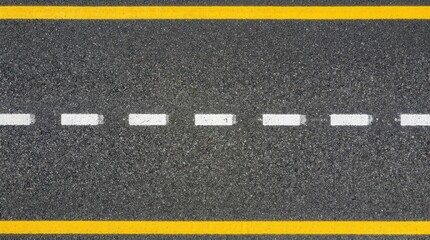 Fototapeta premium Detailed high angle view of textured asphalt road surface with solid yellow edge lines and white dashed markings, providing a clean background for transport and infrastructure projects or