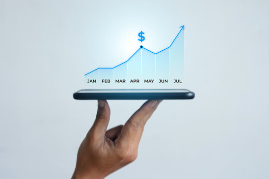 Hand Balancing Smartphone With Growing Stock Market Hologram Against White Background