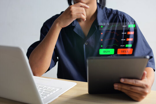 Closeup Male Market Analyst Holding Tablet Near Laptop To Track Investment Hologram