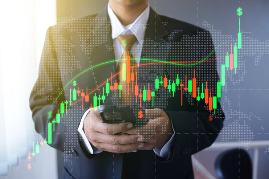 Businessman Using Smartphone to Track Candlestick Hologram at Workspace