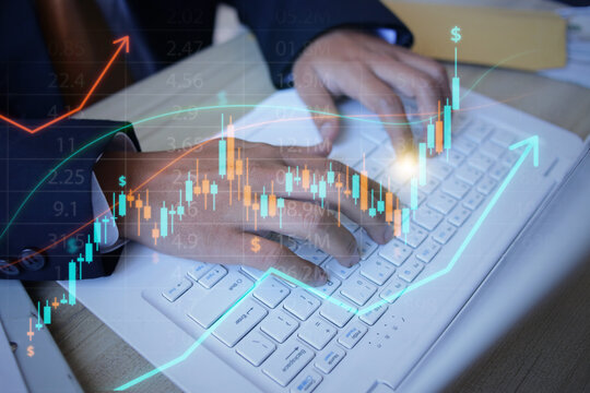 Close Up Hands Typing on Laptop to Analyze Financial Growth Hologram at Workspace