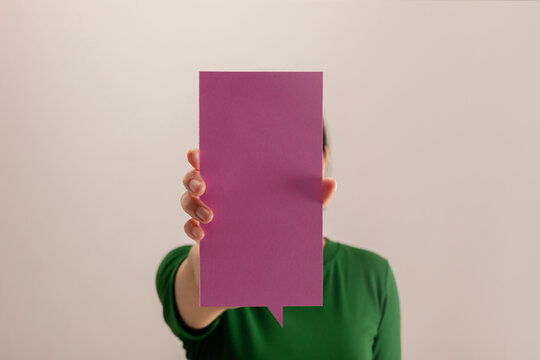 Woman holding a blank square card, communication, identity, messaging