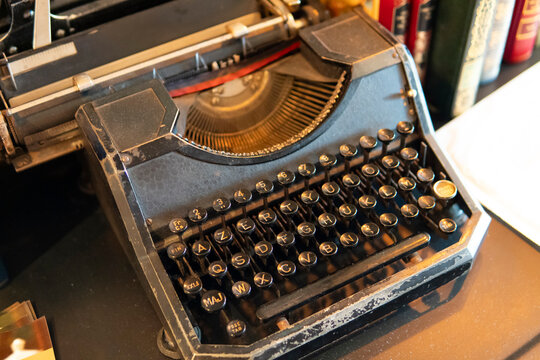 Old black typewriter with vintage keyboard on desk in Verdun, France