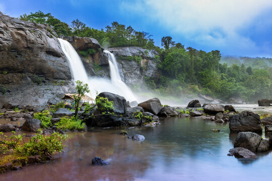 Gorgeous landscape, with Athirappilly Waterfall and foggy forest on background. Kerala India.