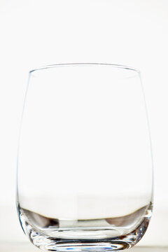 Empty clear glass tumbler on a white background