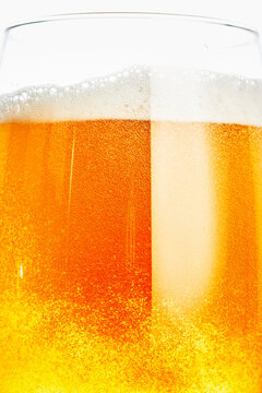 Close-Up of Golden Beer Glass with White Foam Head
