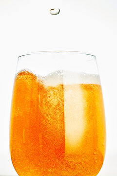Glass of Cold Beer with Falling Droplet