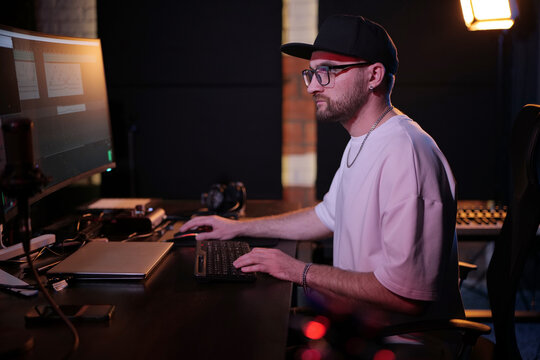 Professional Music Producer Editing Sound On Computer