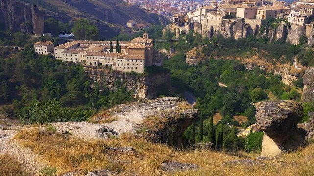 Parador de Cuenca and San Pablo Bridge surrounded by forested cliffs in Castilla La Mancha