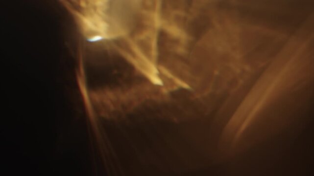Slow motion real lens flare from back sunlight over dark background for overlay