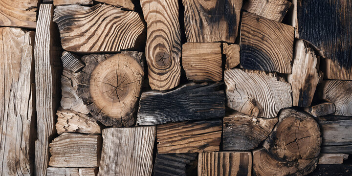 Walnut brown charred firewood log stack pattern wall texture background