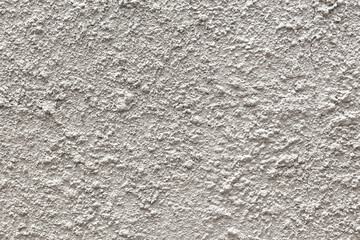 Obraz premium a rough, white concrete plaster wall texture.The material is used for exterior or interior wall decoration and is typically made from cement, lime, and sand.