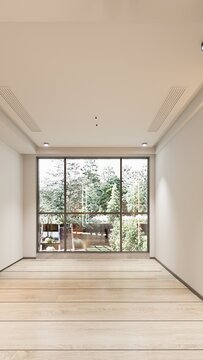 Empty modern room with large window and wooden floor showcasing natural light