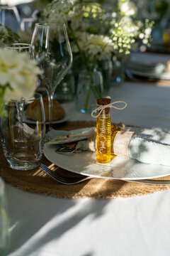 Wedding place setting with an olive oil favour