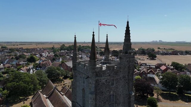 Aerial view of an old stone church in England on a sunny summer afternoon