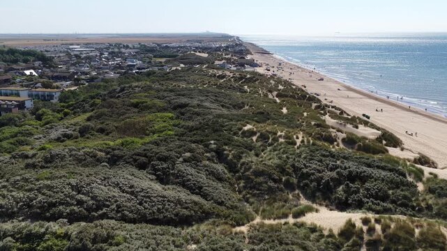 Aerial view of sand dunes and beach along the coastline of Camber Sands in England