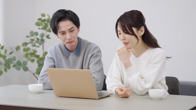 パソコンを見る夫婦・カップル