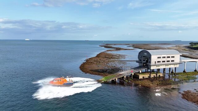 Dramatic RNLI lifeboat Lunch speeding out to sea drone tracking Bembridge UK