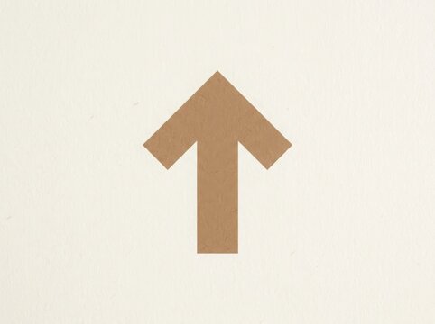 A simple brown arrow pointing up made from recycled craft paper texture on a neutral surface