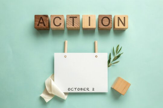 Wooden blocks spelling out the word ACTION next to a blank calendar page with the date OCTOBER 2 marked, symbolizing a call to take action on a specific date