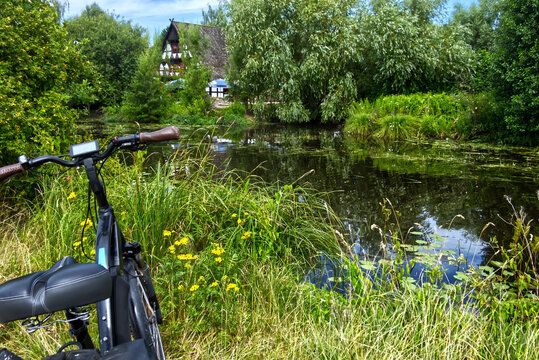 E bike parked by a tranquil pond, exploring german countryside during a relaxing bicycle tour in summer