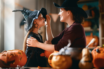 Obraz premium Happy Family Halloween Celebration at Home with Mother and Daughter
