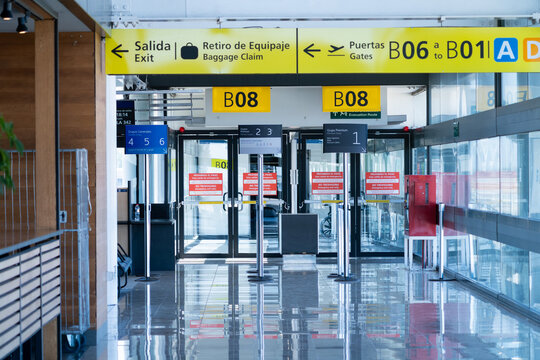 Empty airport gate area with yellow direction signage