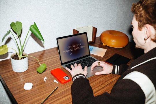The marketing side of work unfolds on a laptop at a simple desk.
