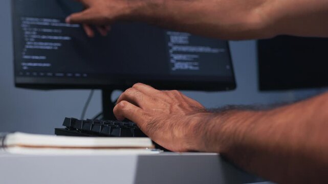 Software Engineer Hands Working on Computer Keyboard, Reviewing Code and Developing AI Software Application in Nighttime Office.