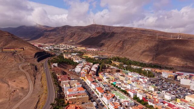 Ambient drone exploration of the Morro Jable town known for its beaches, like vast Playa del Matorral, with its Morro Jable Lighthouse. Drone POV of Fuertaventura Island.