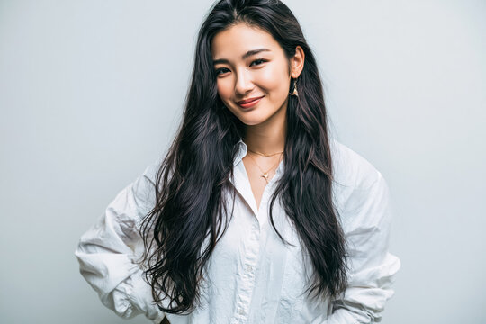 Woman portrait asian woman smiling woman long black hair white shirt studio portrait confident expression isolated background